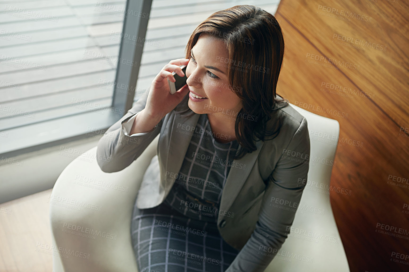 Buy stock photo Shot of a young businesswoman talking on a cellphone