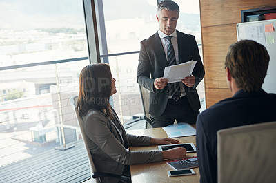 Buy stock photo Shot of a team of professionals having a meeting in a boardroom