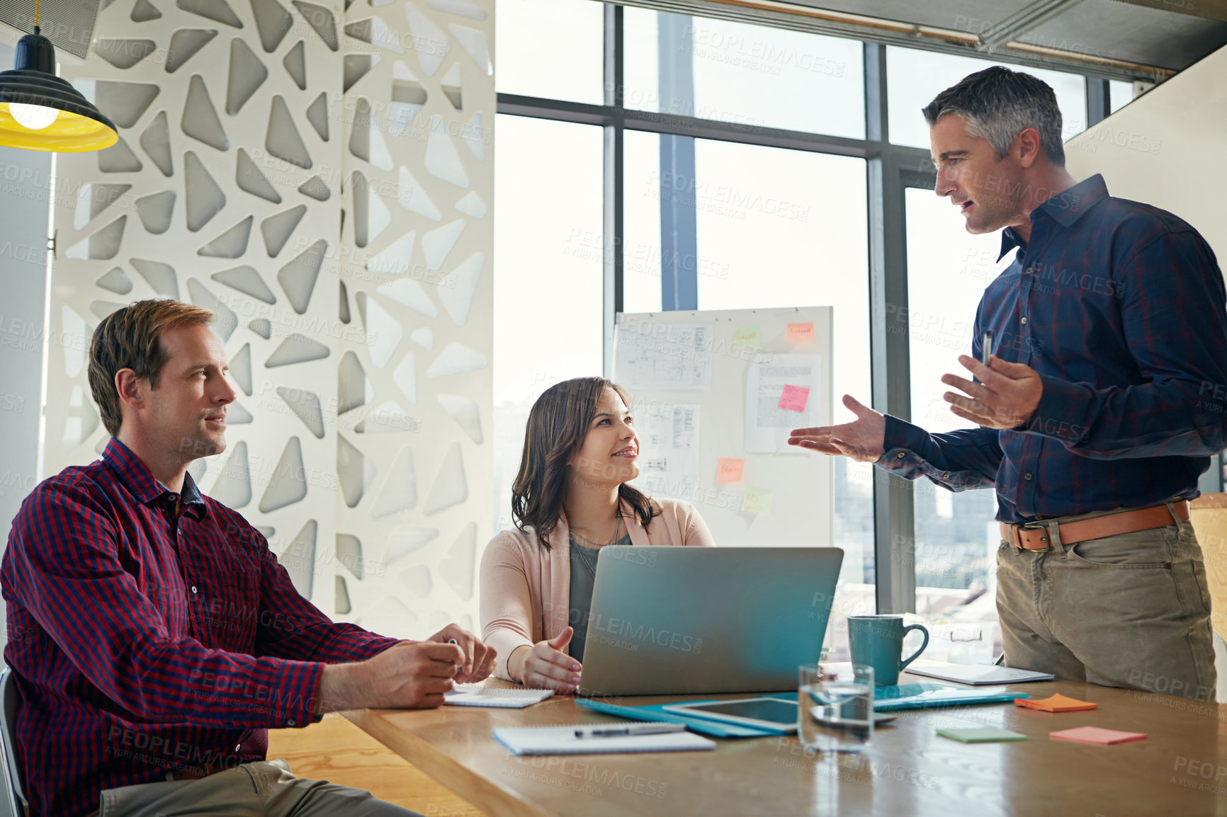 Buy stock photo Shot of a group of businesspeople having a meeting