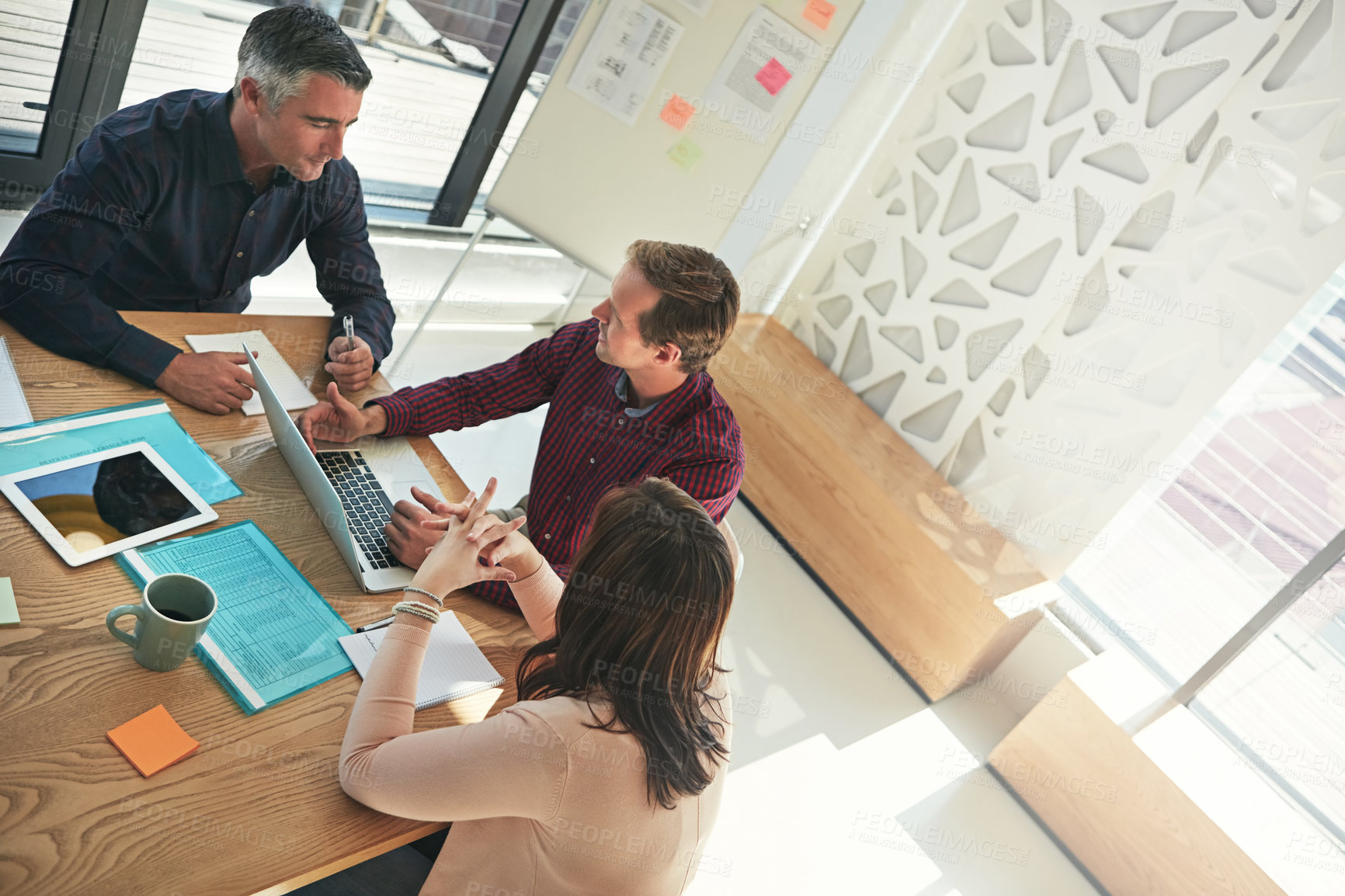 Buy stock photo Shot of a group of businesspeople having a meeting