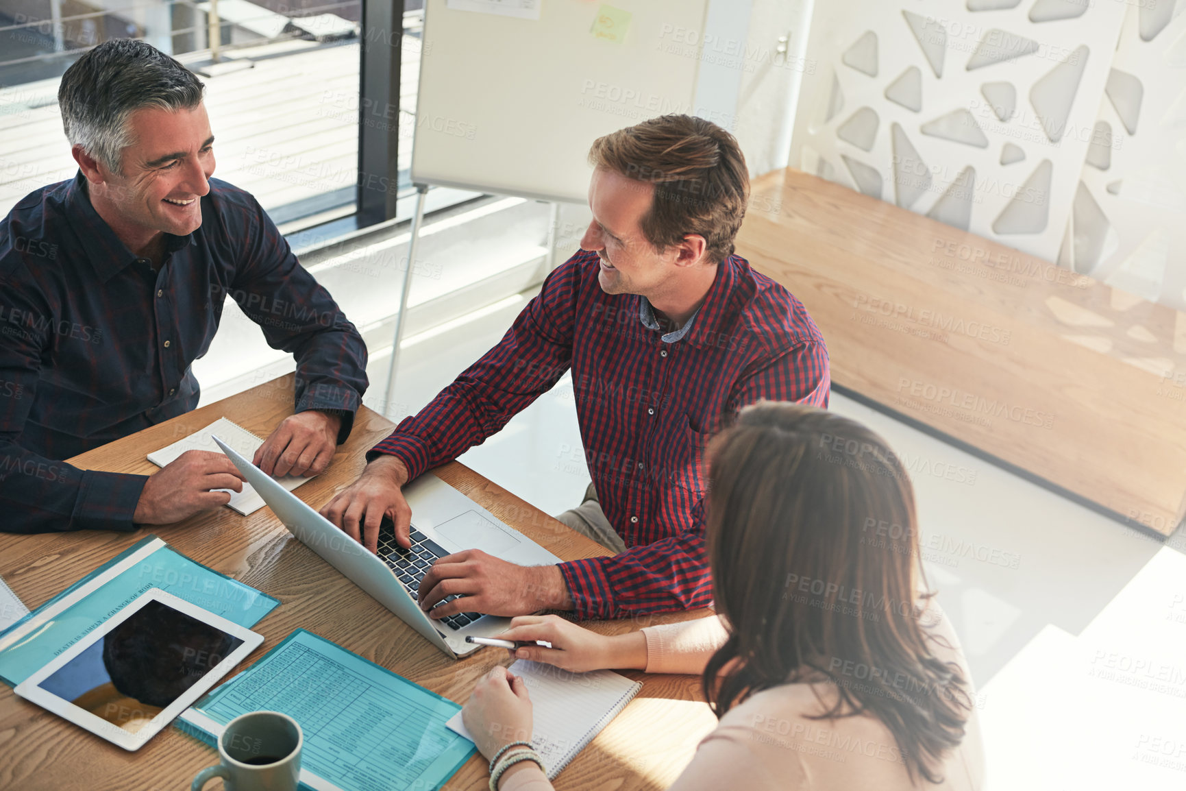 Buy stock photo Shot of a group of businesspeople having a meeting