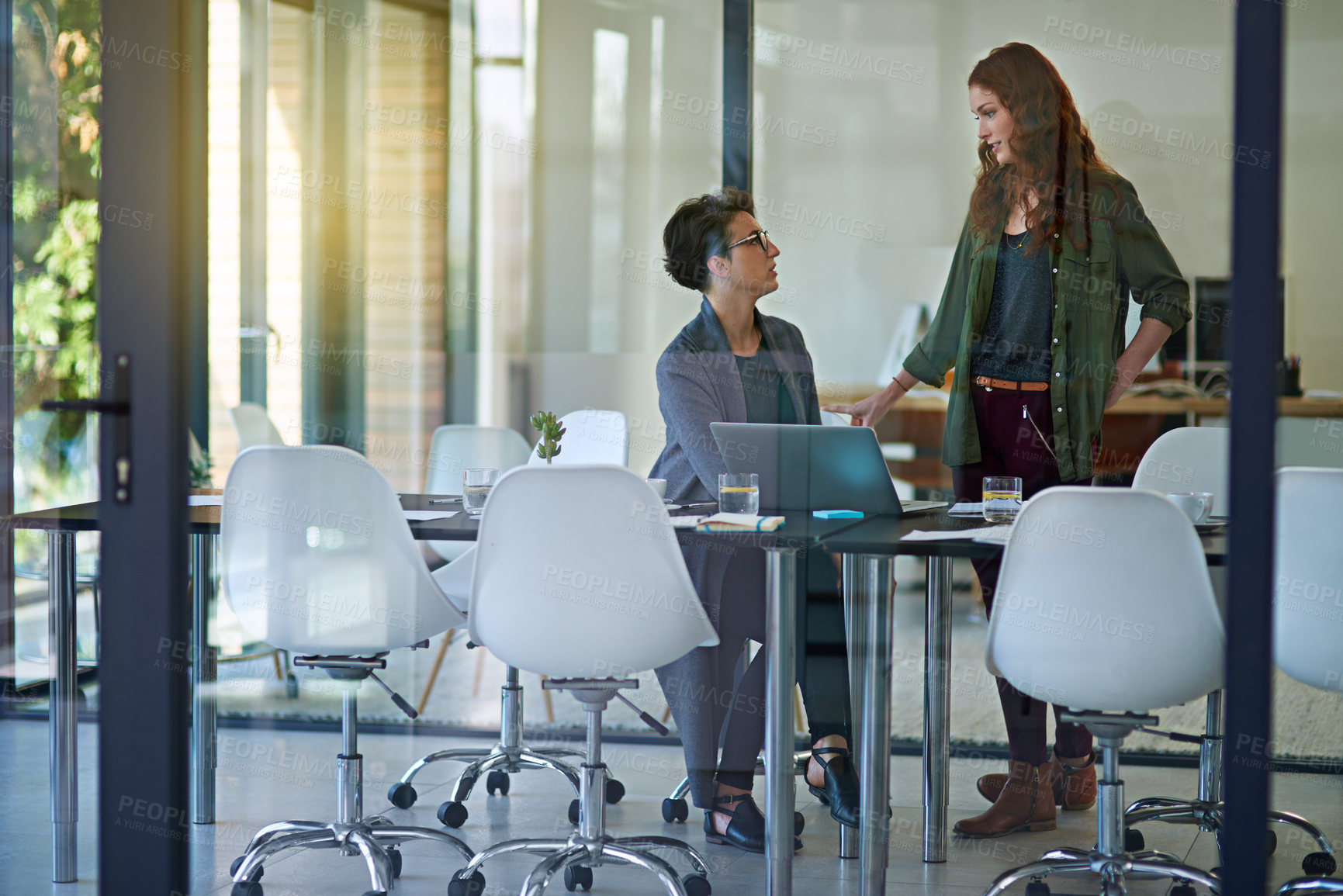 Buy stock photo Women, laptop or talking in startup meeting for brainstorming, research or planning together. Business people, partnership or designers speaking of teamwork, collaboration or creative project ideas