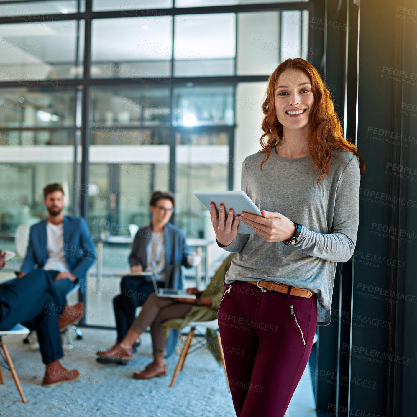 Buy stock photo Portrait of a young creative standing in an office with colleagues in the background