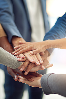 Buy stock photo Cropped shot of a group of colleagues joining their hands in unity
