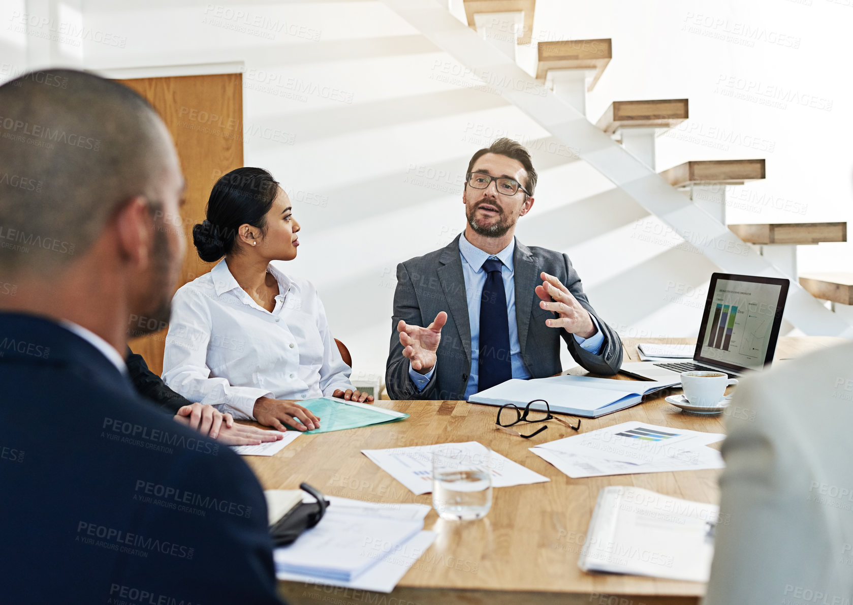 Buy stock photo Cropped shot of a group of businesspeople meeting in the boardroom