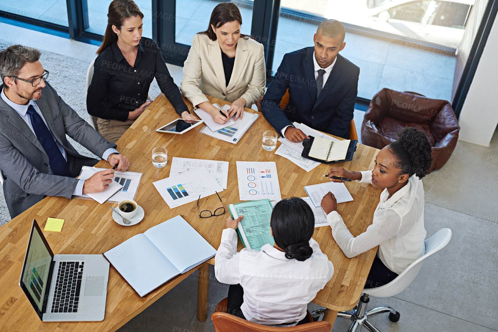 Buy stock photo Cropped shot of a group of businesspeople meeting in the boardroom