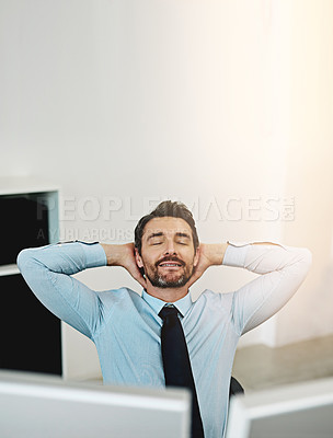 Buy stock photo Shot of a mature businessman relaxing at his work desk