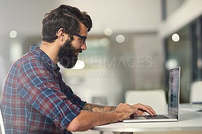 Buy stock photo Shot of a young designer working on his laptop