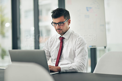 Buy stock photo Cropped shot of a young businessman working in his office