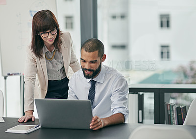 Buy stock photo Cropped shot of two young businesspeople working in the office