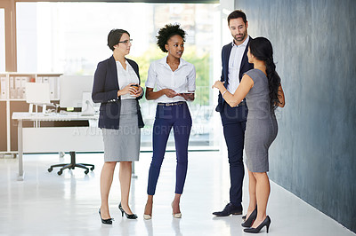Buy stock photo Full length shot of a group of businesspeople talking in the office