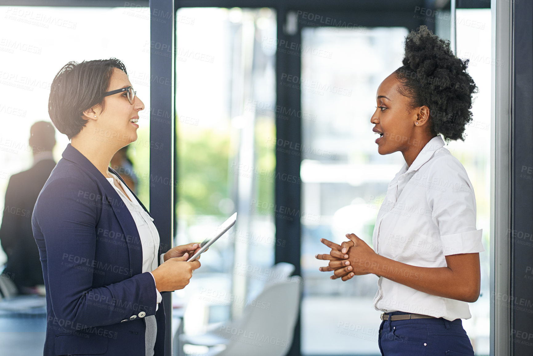 Buy stock photo Cropped shot of two businesswomen meeting outside the boardroom before their presentation