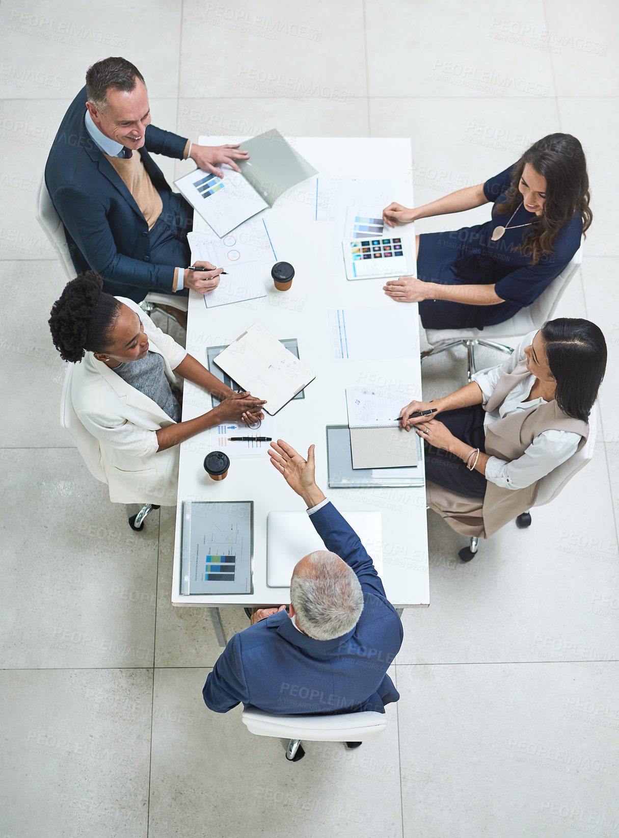 Buy stock photo Teamwork, talking and meeting group of corporate colleagues planning, brainstorming or discussing ideas. Above desk of leader asking diverse team questions and collaborating with reports or documents