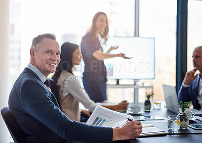 Buy stock photo Portrait of a businessman sitting in a boardroom presentation with colleagues