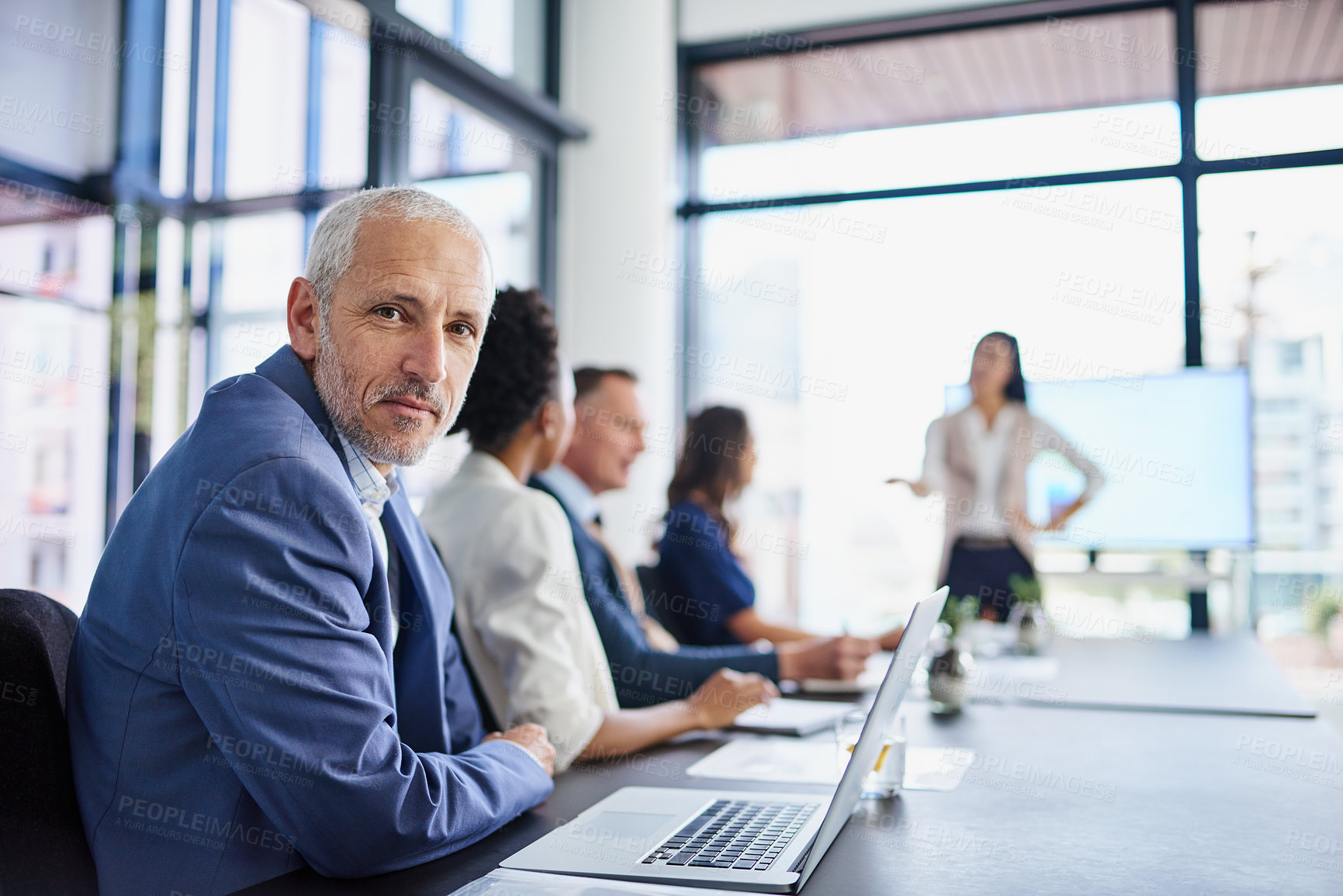 Buy stock photo CEO, mature man and portrait in boardroom, laptop and listening to presentation by employee for team. Meeting, boss and online for project, collaboration and strategy for deal, editor and publishing