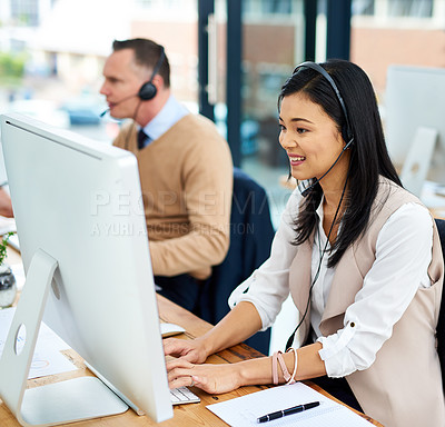 Buy stock photo Cropped shot of a young businesswoman working alongside a male colleague in the office