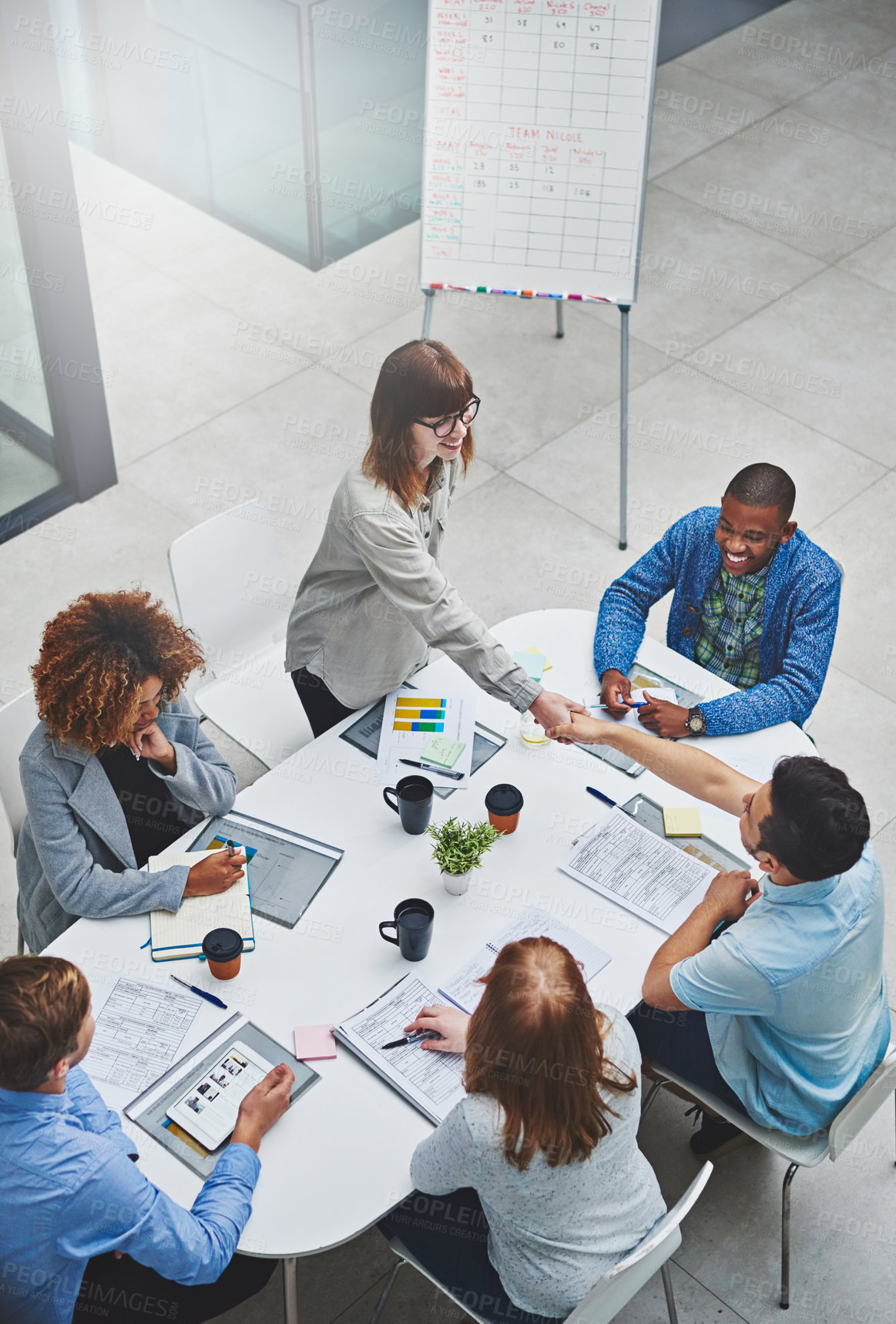 Buy stock photo Business people, handshake and meeting with creative work and management of news team. Happy, greeting and thank you above with diversity of content creation staff at office collaboration session