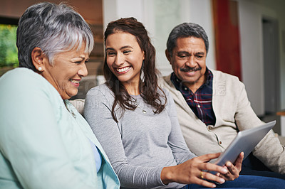 Buy stock photo Senior parents, woman and tablet in living room for connection or bonding with tech. Family, home and mature people with young, female person and happy for togetherness on couch in community
