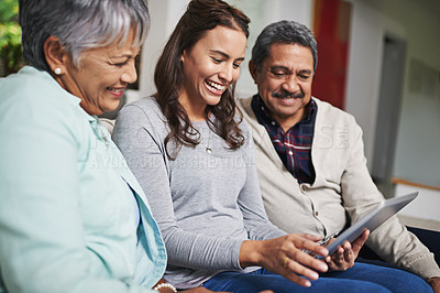 Buy stock photo Senior parents, woman and tablet with smile in living room for connection or bonding with tech. Family, home and mature people with young, female person and happy for together on couch in community