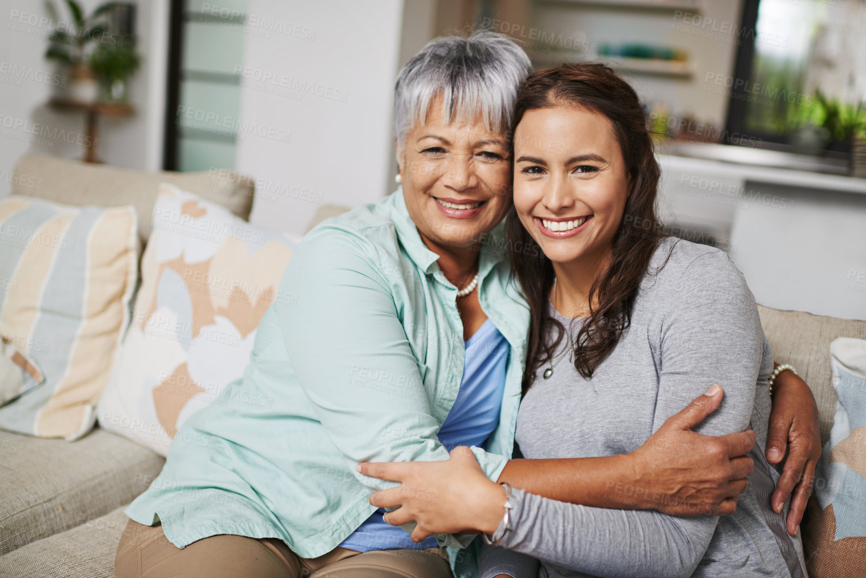 Buy stock photo Mother, smiles and hugs woman in home portrait for love, family or sharing moment together on sofa. People, happy and embrace in living room couch for bonding, connection and relationship growth