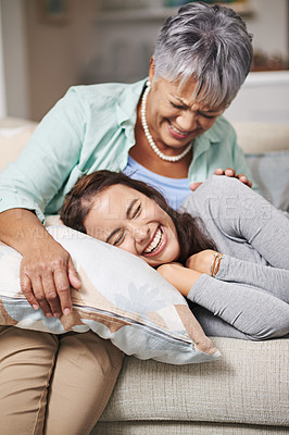 Buy stock photo Elderly, mom and laugh with daughter on sofa with pillow for happiness in retirement for bonding with happy. Mature, woman and couch with together in living room in family home for relax with care