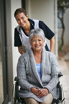 Buy stock photo Portrait of a senior woman in a wheelchair being for for by a nurse at a retirement home