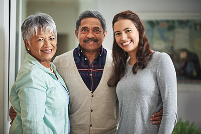 Buy stock photo Senior parents, daughter and portrait of family in living room with embrace for connection, love and bonding together. Smile, elderly couple and happy woman for hug, support and care in home