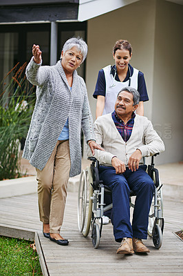 Buy stock photo Shot of a senior woman showing her husband around a retirement home with a nurse