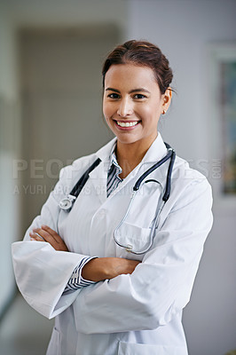 Buy stock photo Portrait of a cheerful young doctor crossing her arms