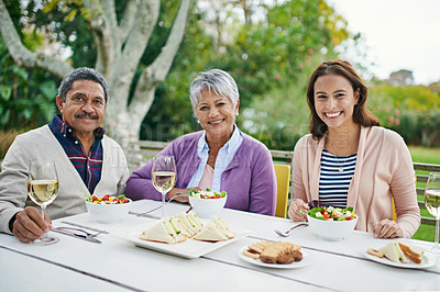 Buy stock photo Retired parents, female daughter and lunch with table outdoor for eating, enjoyment and quality time together for bonding. Family, smile and portrait with food or wine for meal on holiday in nature