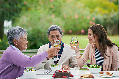Buy stock photo Cropped shot of a family enjoying a birthday lunch outside