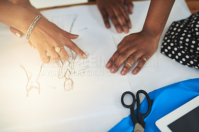 Buy stock photo Cropped shot of two designers discussing a sketch