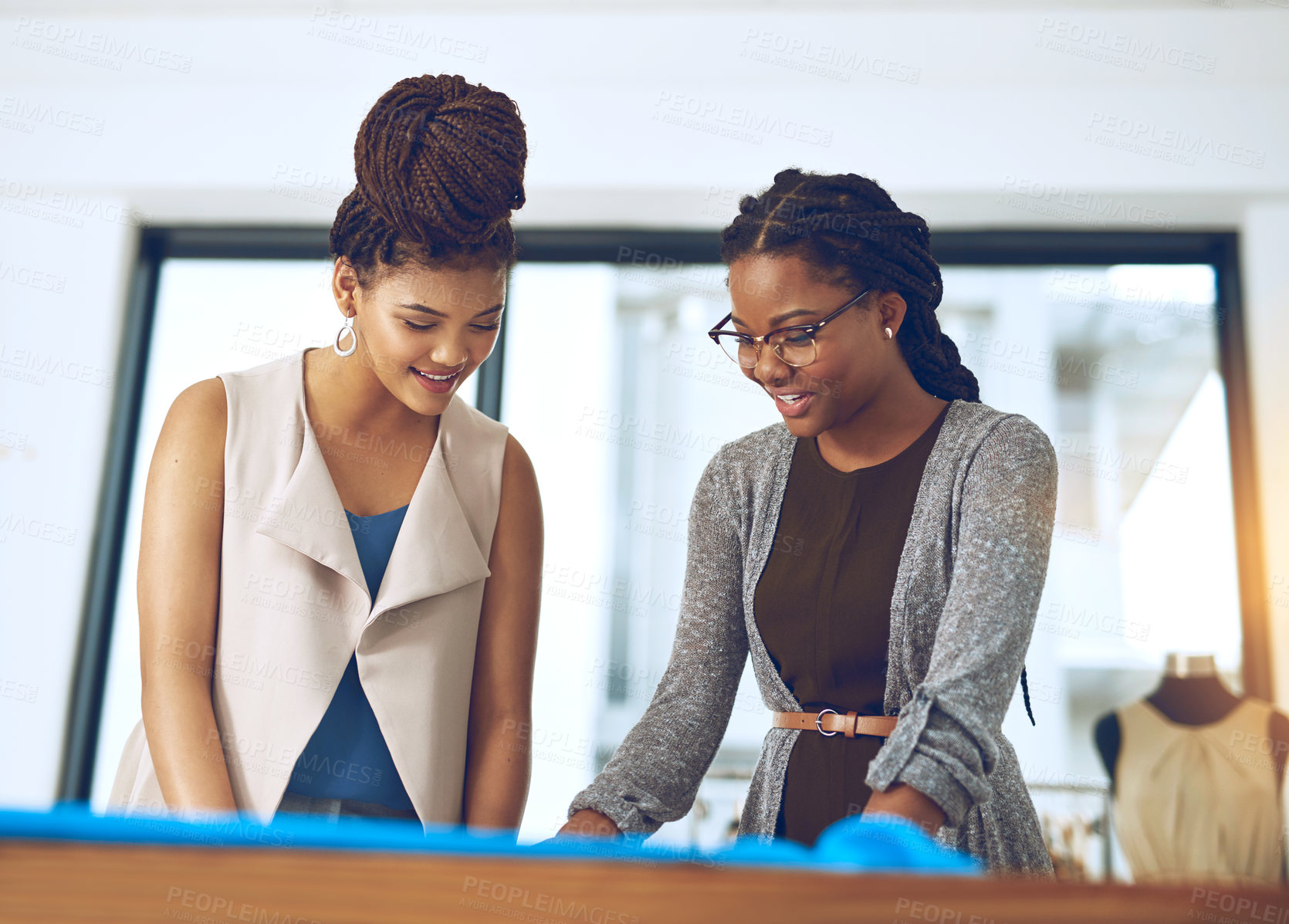 Buy stock photo Shot of two young designers collaborating on a new design