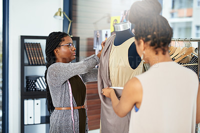 Buy stock photo Shot of fashion designers taking measurements on a new design