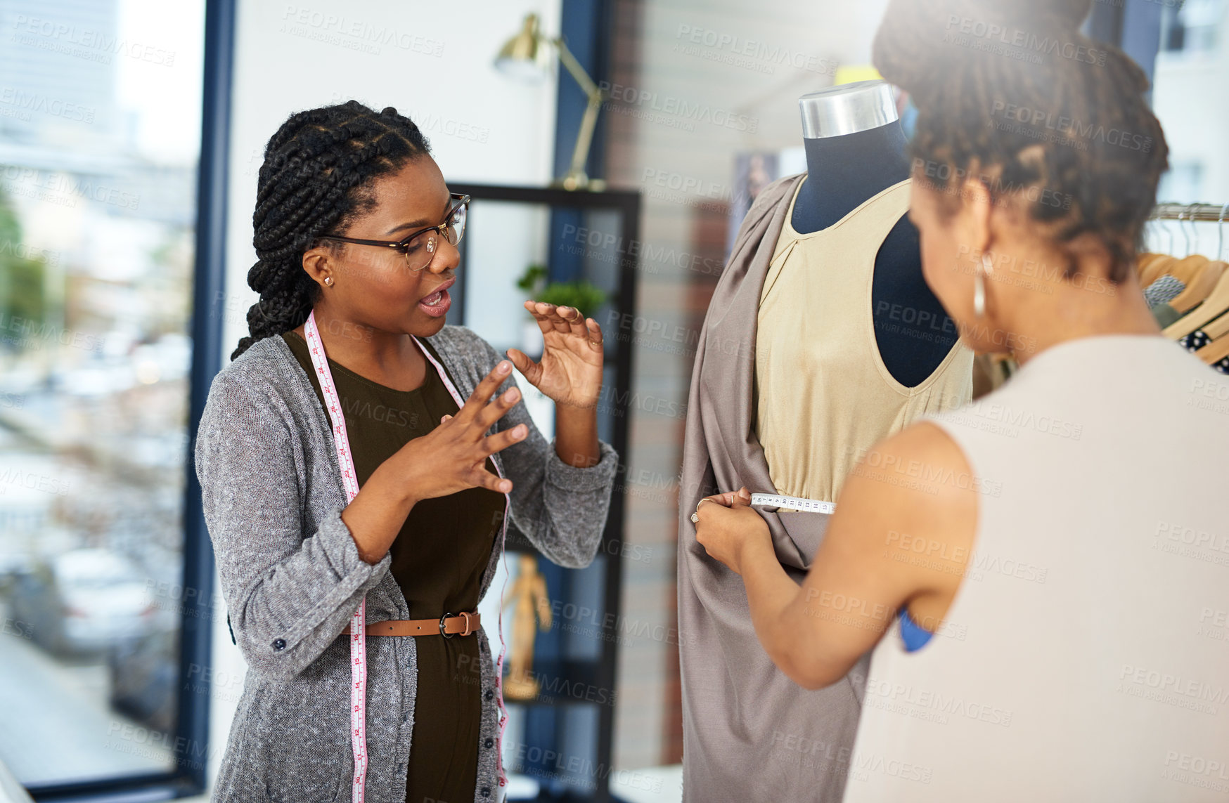 Buy stock photo Talking, fashion designer and women in boutique with mannequin for textile, material and style in tailor shop. Small business, meeting and people with model for clothes, pattern and measure fabric