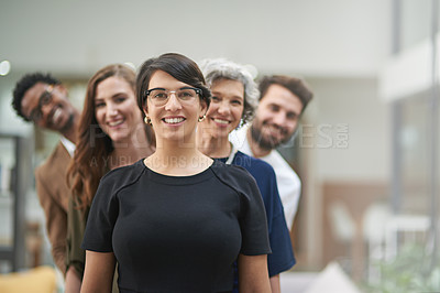 Buy stock photo Cropped portrait of a diverse group of businesspeople standing behind each other in their office