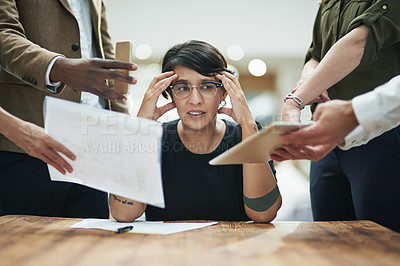 Buy stock photo Cropped shot of a young businesswoman feeling overwhelmed by her colleagues in the office