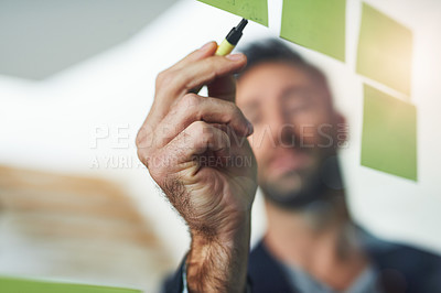 Buy stock photo Cropped shot of a businessman working on a glass wall in the office
