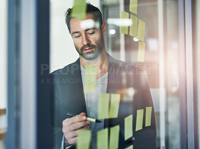 Buy stock photo Cropped shot of a businessman working on a glass wall in the office