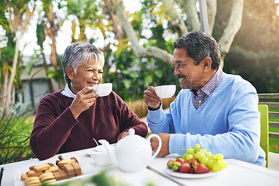 Buy stock photo Shot of a happy older couple having tea together outdoors