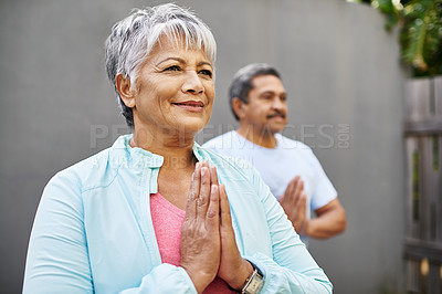Buy stock photo Shot of an older couple meditating together outdoors