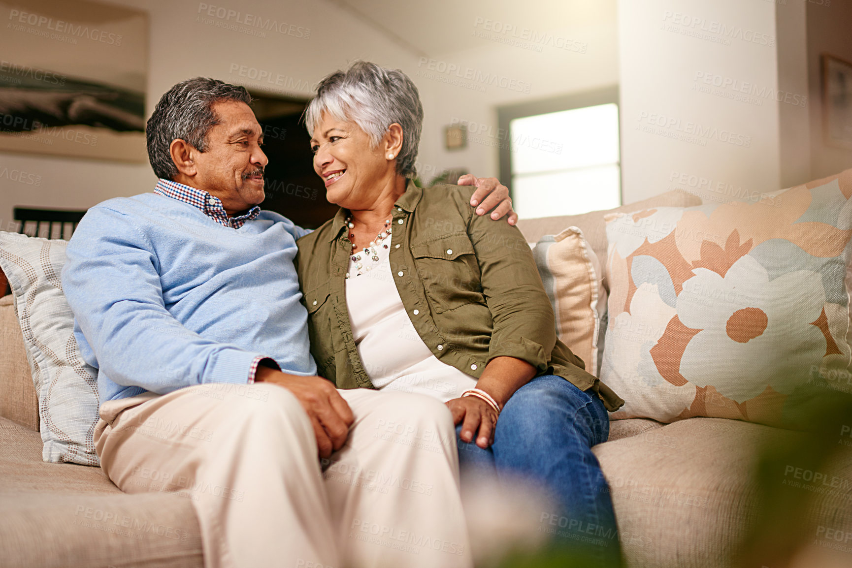 Buy stock photo Shot of a happy older couple relaxing on the sofa together at home