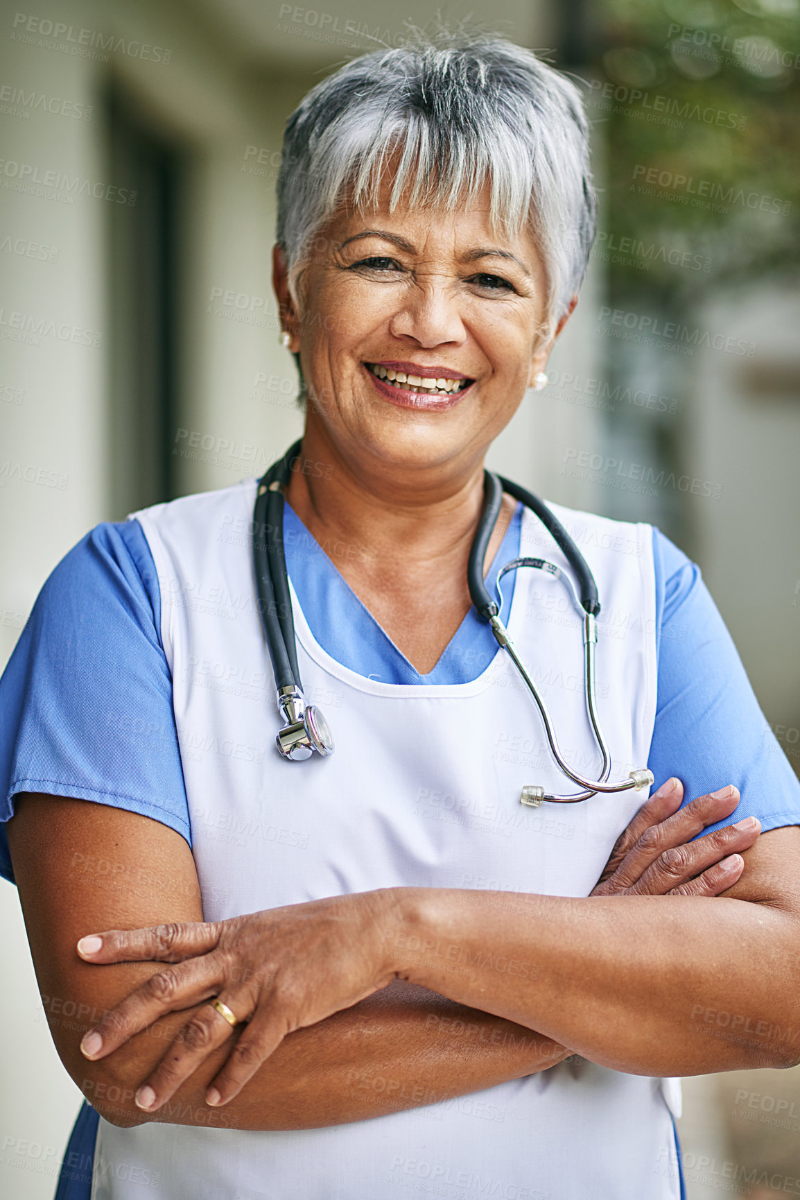 Buy stock photo Portrait, woman and senior nurse with pride outdoor for healthcare, hospice and sick. Medical care, stethoscope and face of mature female worker at clinic for helping elderly, smile and confidence