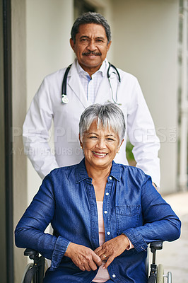 Buy stock photo Portrait of a senior woman in a wheelchair being cared for by a male doctor at a retirement home