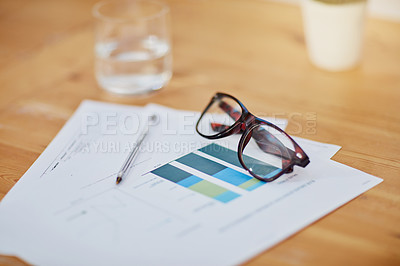 Buy stock photo Still life shot of spectacles on top of some paperwork on a desk
