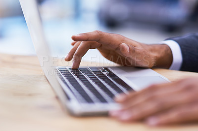 Buy stock photo Closeup shot of a businessman working on a laptop in an office