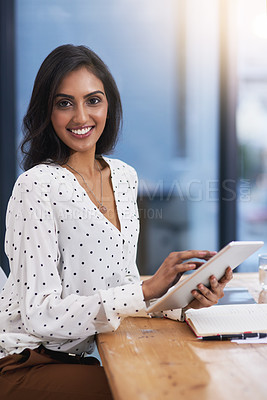 Buy stock photo Portrait of a beautiful young businesswoman working on a digital tablet in a modern office