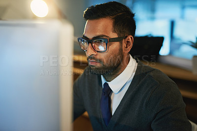 Buy stock photo Cropped shot of a young businessman working late at the office