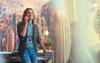 Buy stock photo Shot of a young woman using a mobile phone in her store