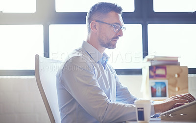 Buy stock photo Shot of a businessman working at his desk
